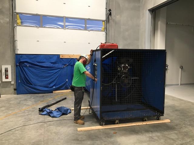 Accurate-Airtight Exteriors Expert Conducting Air Barrier Testing With Commercial Blower Door Equipment