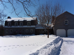 Front view of a snowy home during the winter