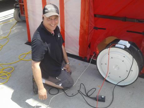 Accurate-Airtight Exteriors' President, Torrance Kramer Conducting A Commercial Blower Door Test