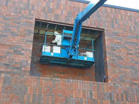 Using A Crane For Commercial Air Barrier Repair Work