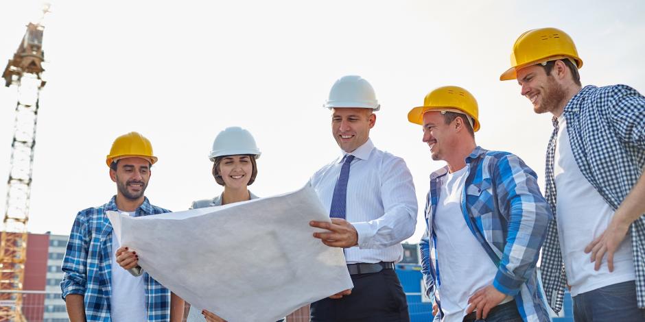 Construction personnel meeting with engineer at job site