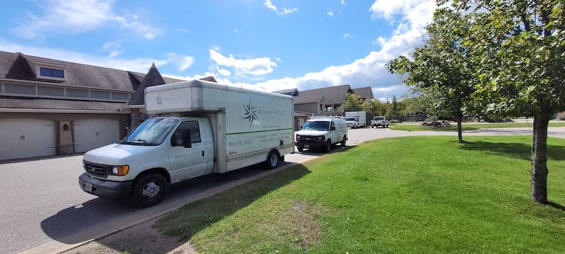 Accurate-Airtight Exteriors Work Vehicles Parked In Front Of Work Site