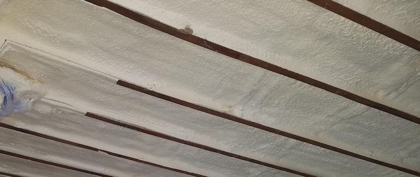 Close-Up Of Spray Foam Insulation On Eaves