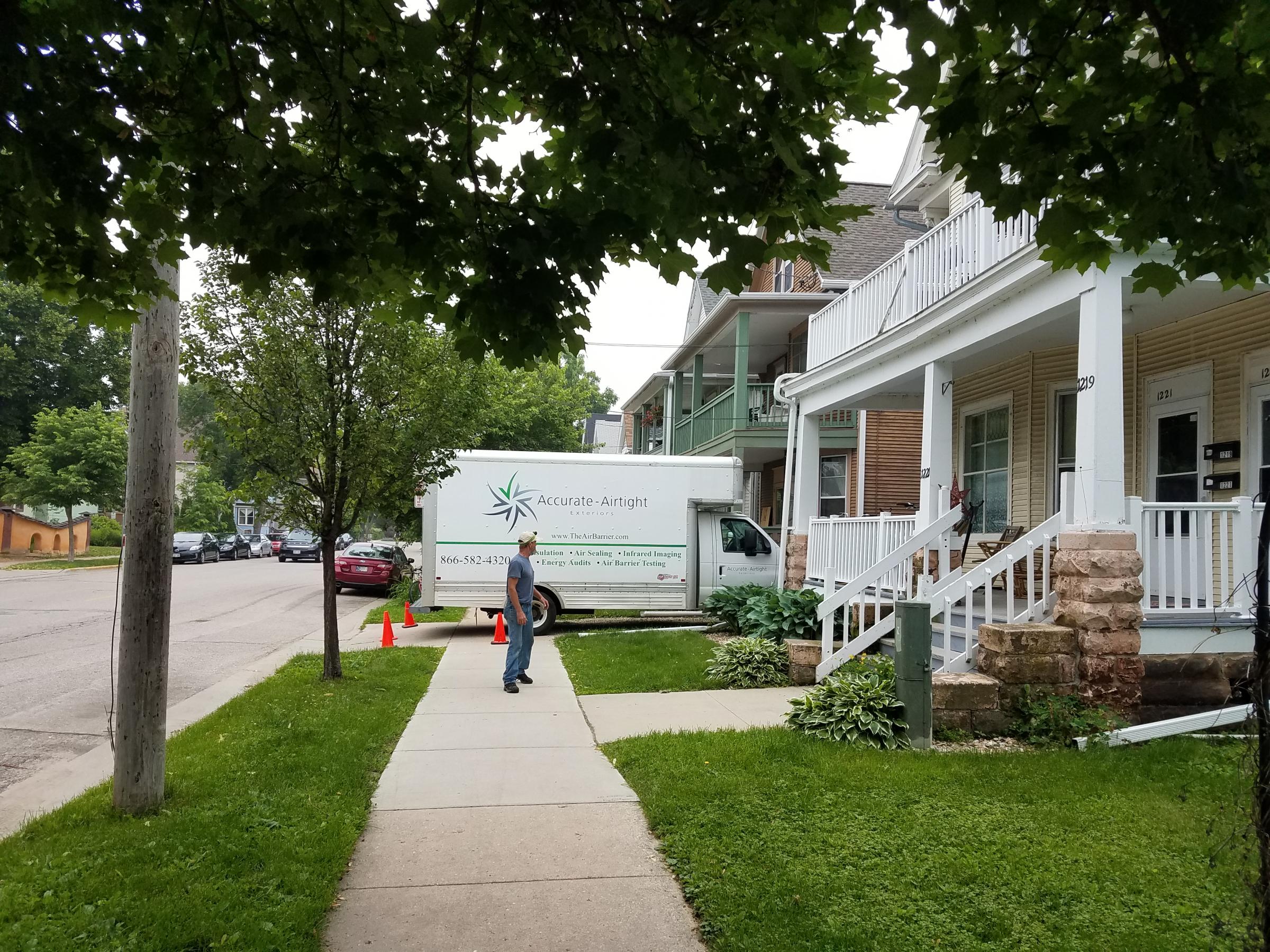an accurate airtight van parked outside a row of homes