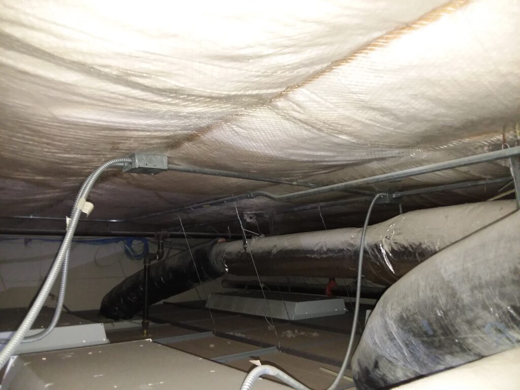 Air sealing project above ceiling tile in a Church facility.