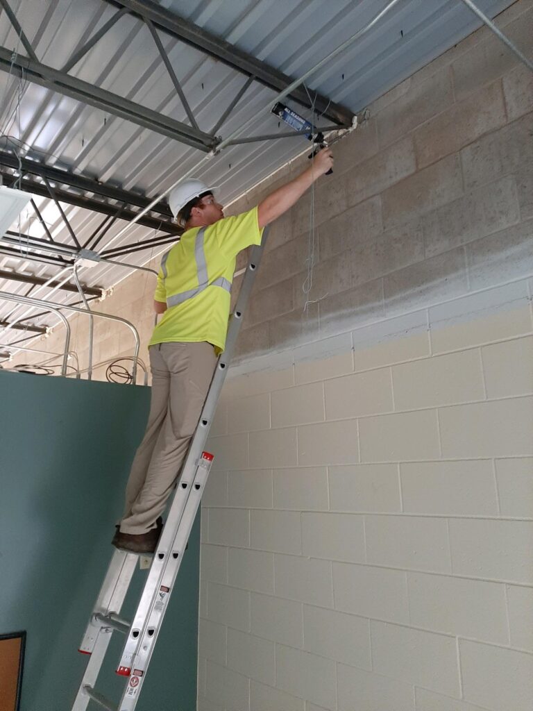 Sealing gaps at wall/roof junction.