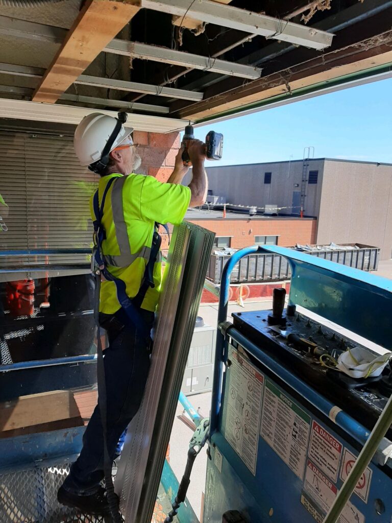 Air barrier repair project in progress at a High School.