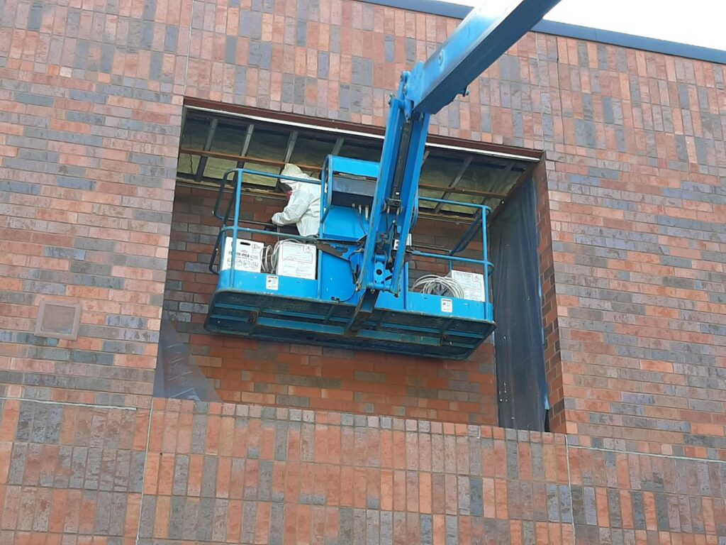 "Cherry picker" used to access location to be sealed at a High School.
