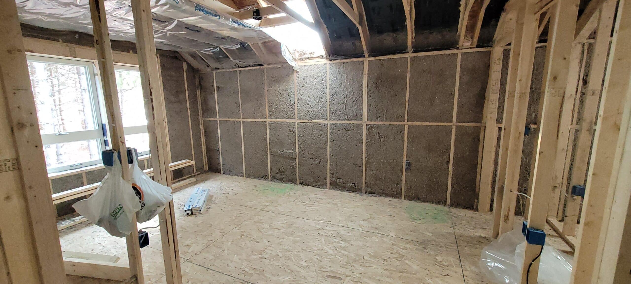 new build room with exposed walls and insulation sheets