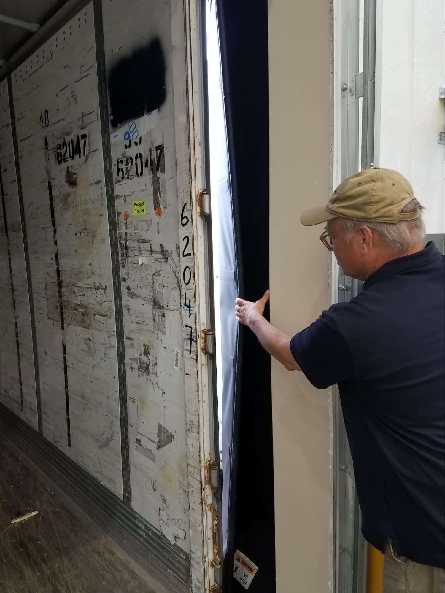 Person inspecting air barrier of commercial building