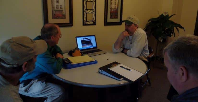Torrance sitting at a table with customer