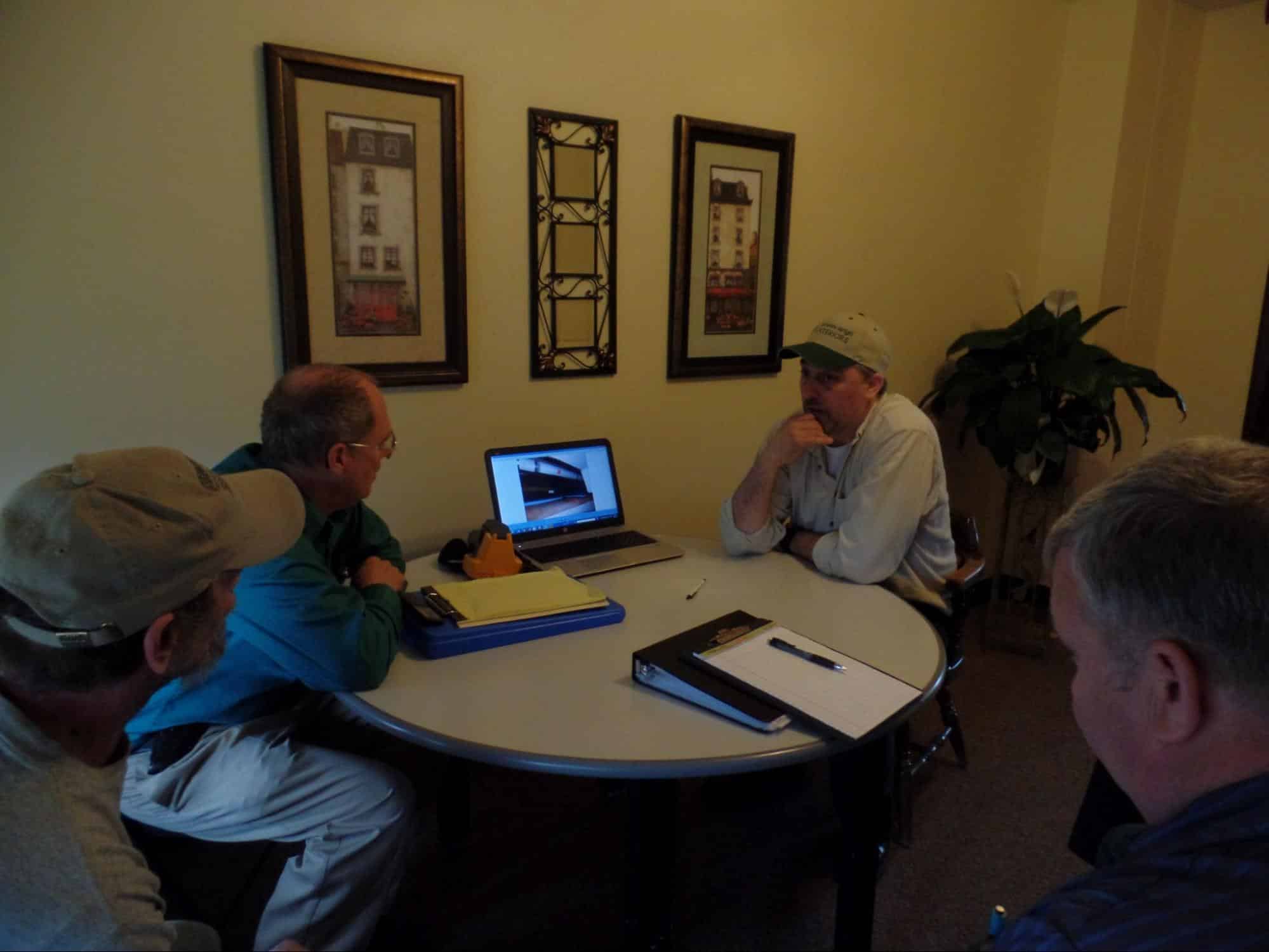 Torrance holding a consulting meeting with customer at table with laptop