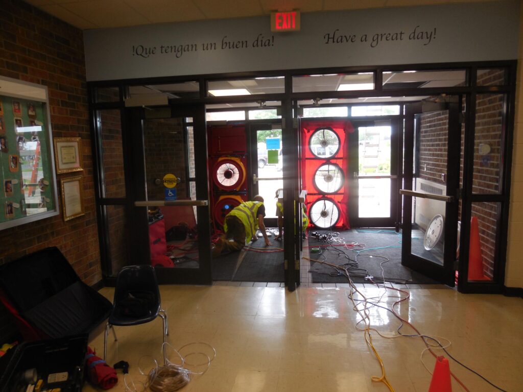 Three TEC blower door fans used to test a housing authority building.