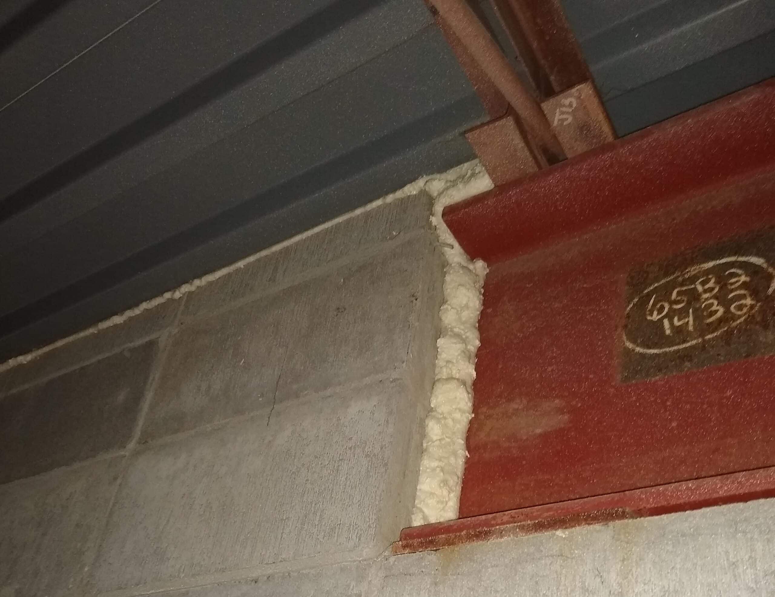 Gaps between dissimilar building materials sealed with one-part spray foam.
