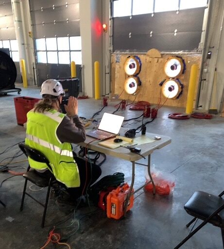 Accurate-Airtight Enclosures Team Using Equipment During Building Assessment
