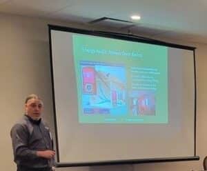 Torrance Kramer of Accurate-Airtight Exteriors giving a presentation on blower door testing.
