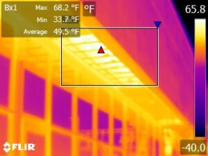 Cold weather infrared camera image of heat loss through an office building cantilever.