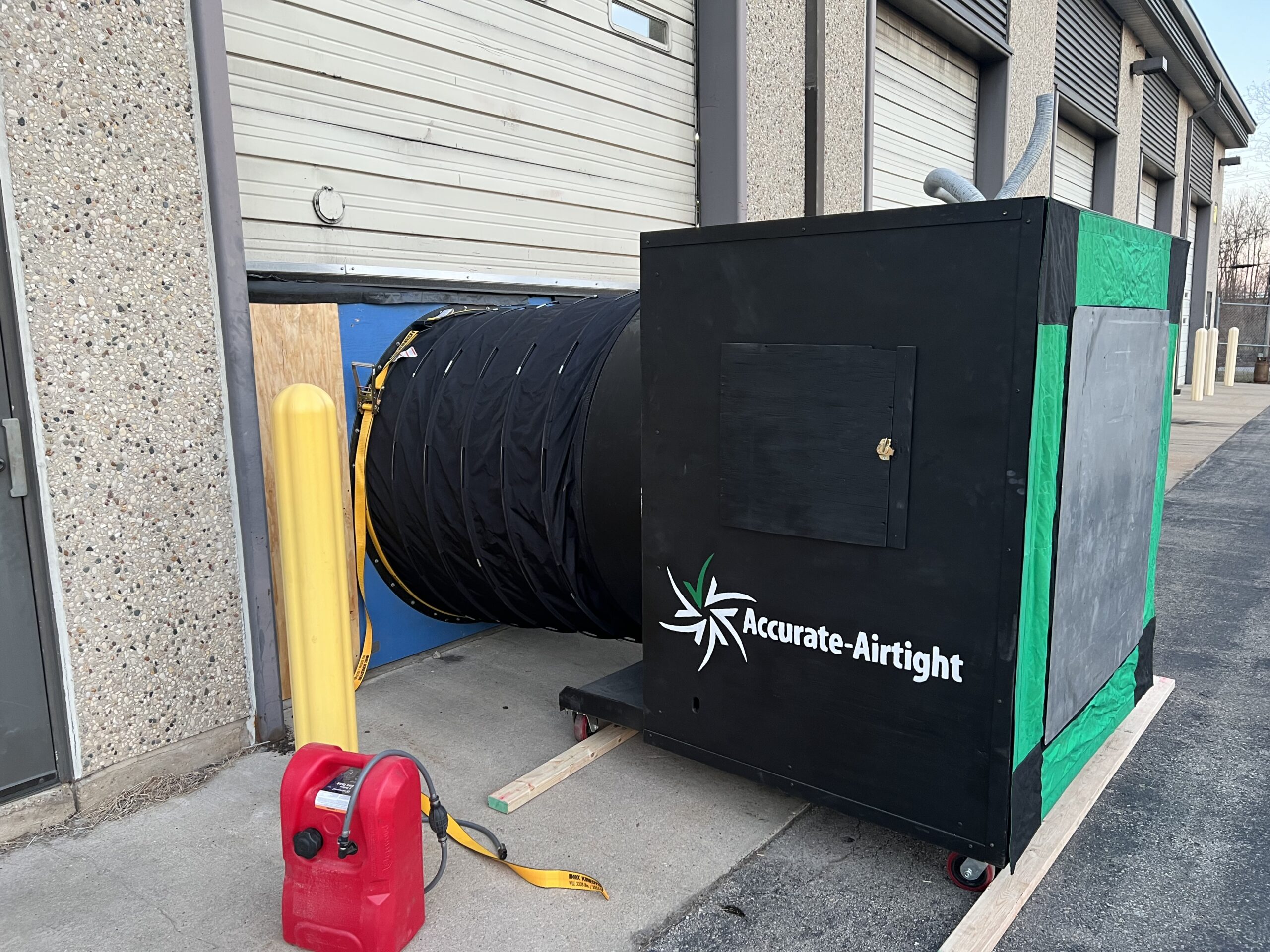 The G54 blower door system has a powerful gasoline engine (gas can in foreground).