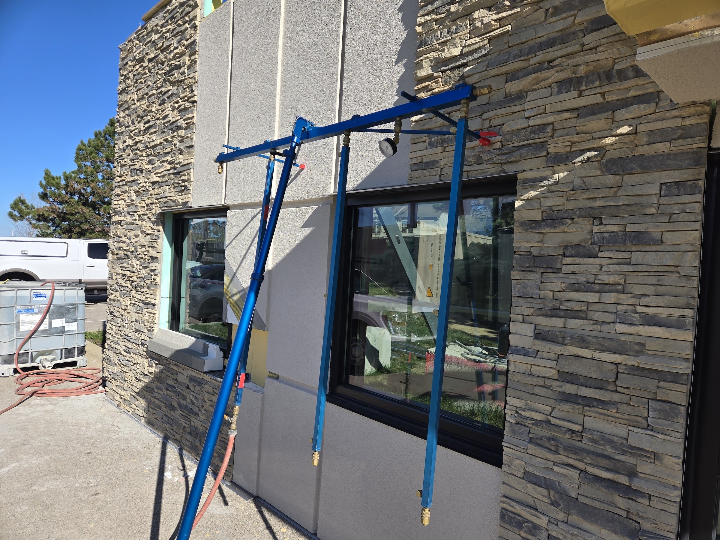 Water spray apparatus setup to test a mockup window.
